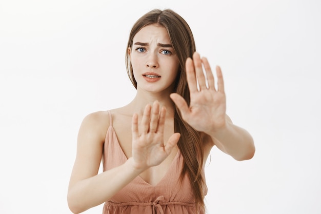 Concerned timid and insecure worried woman doing stop gesture