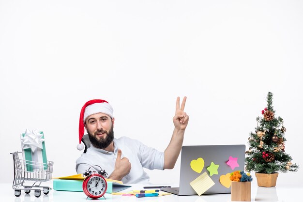 Concerned young businessman with santa claus hat working