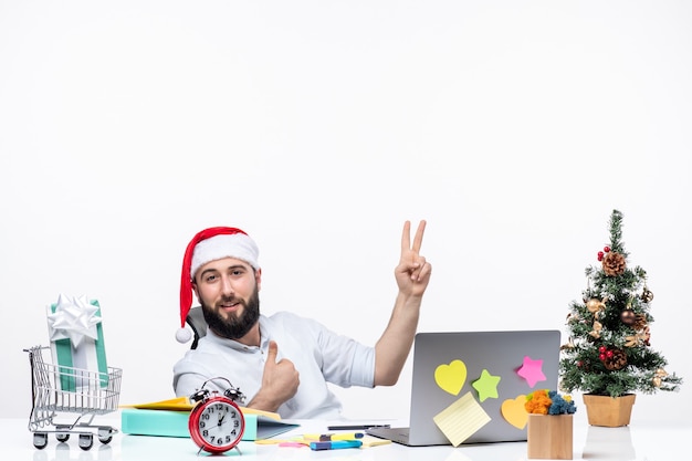 Concerned young businessman with santa claus hat working