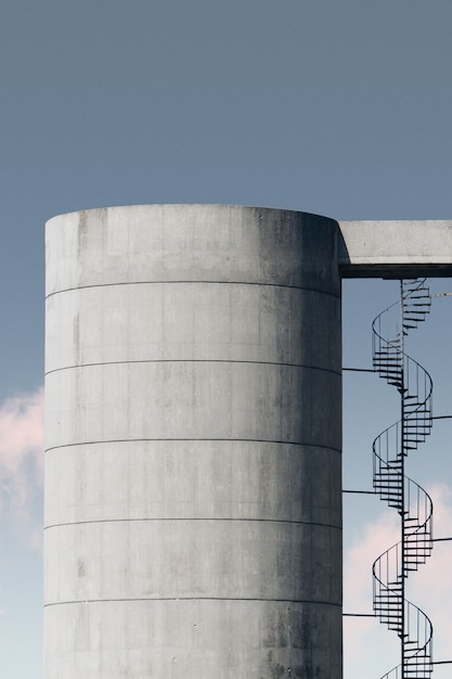 Free photo concrete structure with metal stairway under the blue sky