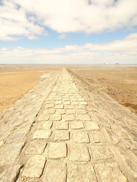 Free Photo concrete walkway around the desert under a sky full of clouds