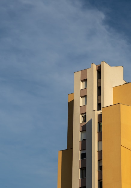 concrete white and brown modern building under the cloudy sky