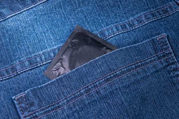 Free photo condom in the back pocket of jeans