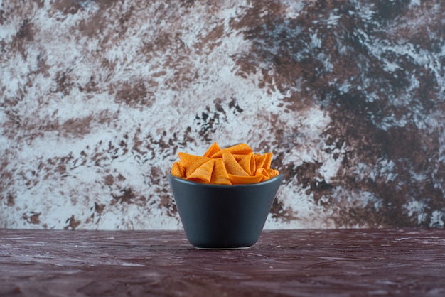 Cone chips in a bowl , on the marble table. 