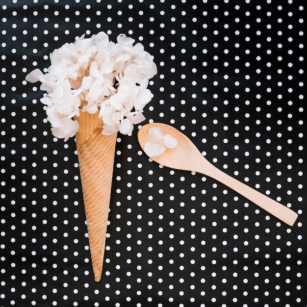 Cone with flowers and spoon with petals