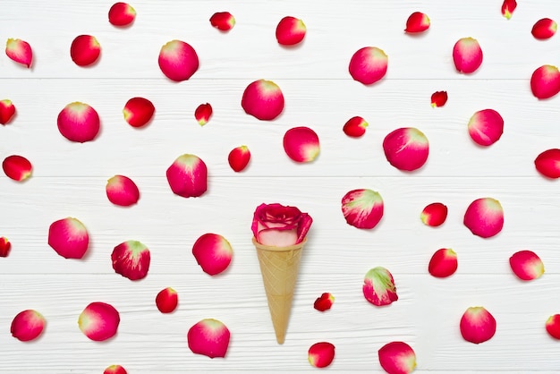 Free photo cone with rose amidst petals