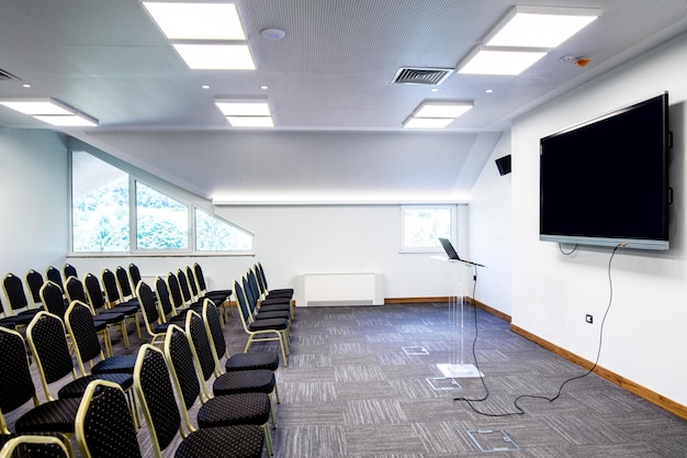 Conference hall empty seats in a row and projection screen before a seminar