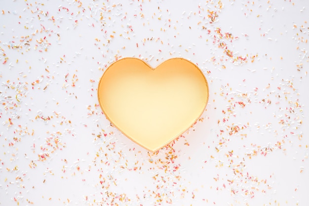 Free photo confetti around golden heart