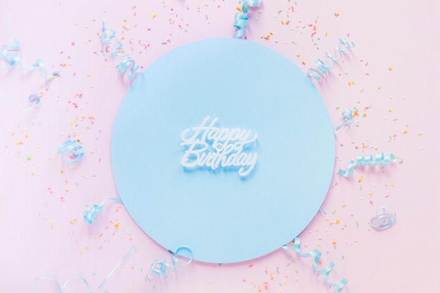 Free photo confetti an streamers around birthday writing