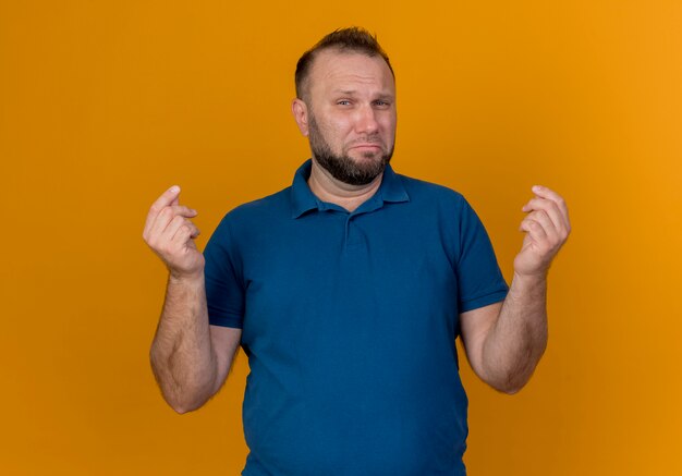 Confident adult slavic man doing money gesture 