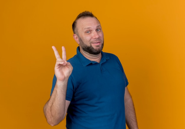 Confident adult slavic man looking doing peace sign 