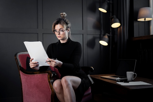 Confident adult woman checking some papers