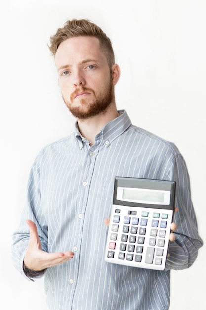 Free photo confident banker showing interest on calculator