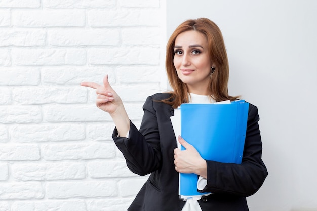 Confident business lady holding her Northbrook and point her finger aside