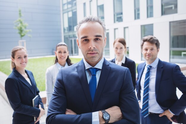 Confident businessman with colleagues