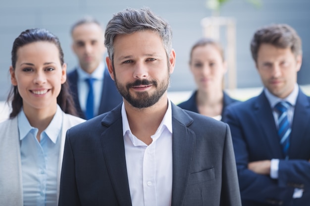 Confident businessman with colleagues