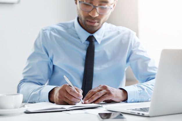 Confident businessman working on his laptop