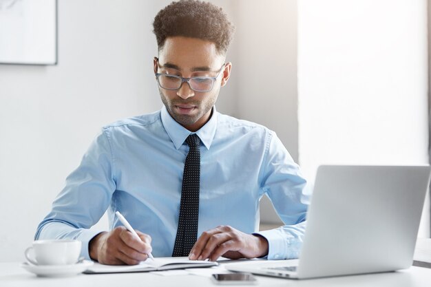 Confident businessman working on his laptop