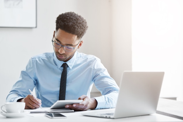 Confident businessman working on his laptop