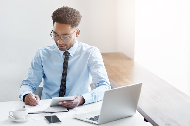 Confident businessman working on his laptop