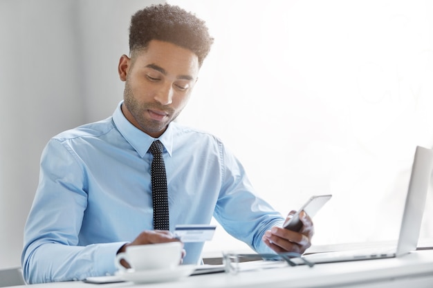 Confident businessman working on his laptop