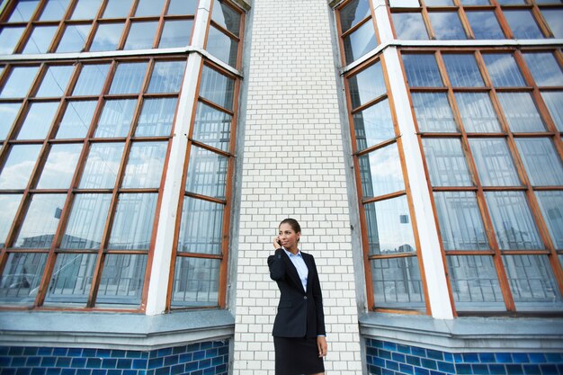 Confident businesswoman with mobile phone