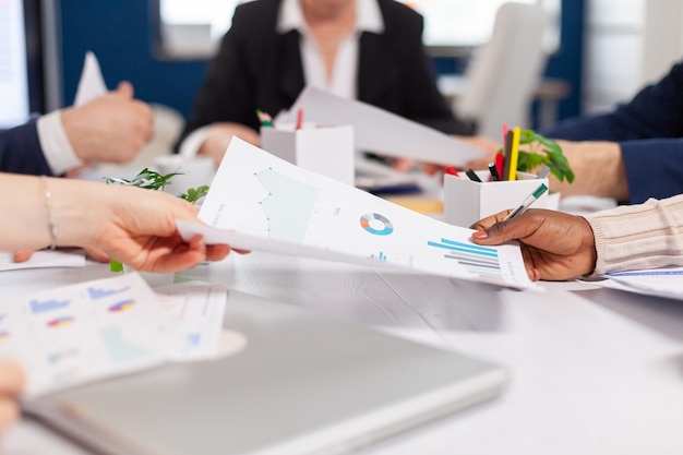 Confident company manager giving working tasks to diverse teamworkers