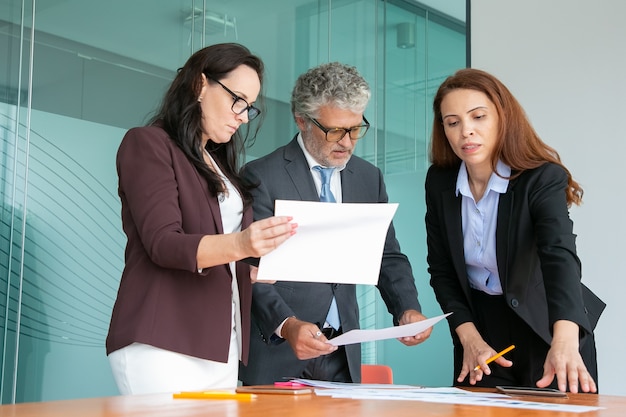 Confident employees discussing project together