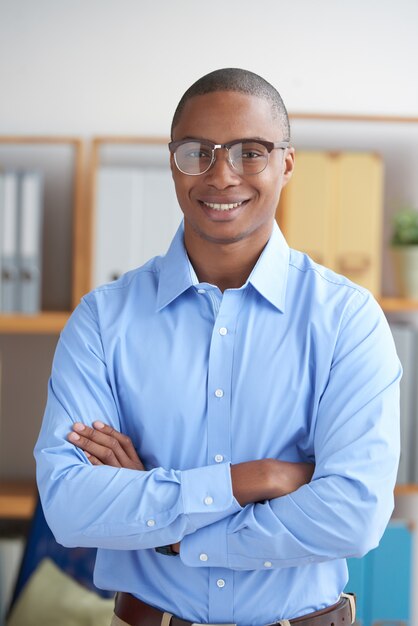 Confident entrepreneur looking at camera with arms folded smiling