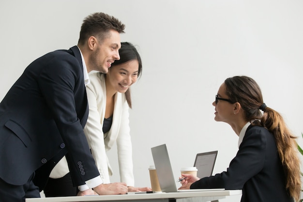 Confident female boss talking to subordinates