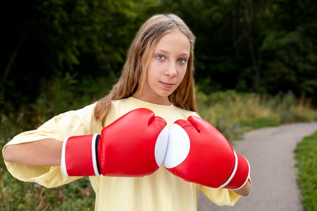 Confident girl with boxing gloves