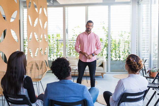 Confident male speaker holding seminar