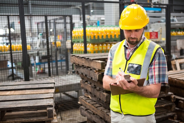 Confident male worker noting about products