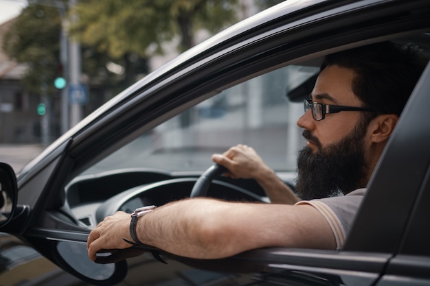 Free photo confident man driving a car