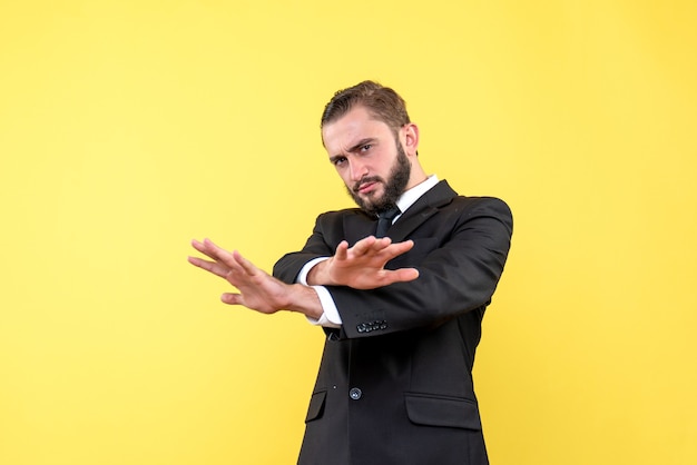 Confident man manager showing stop gesture with crossing hands