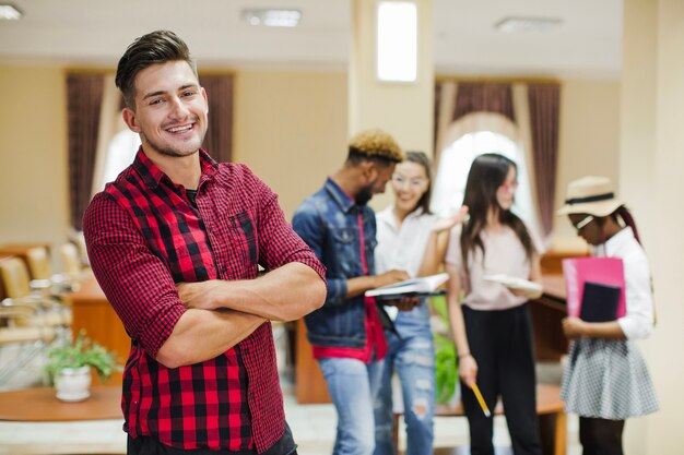 Confident man posing in classroom