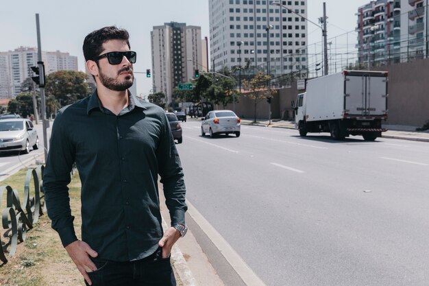 Confident man walking near road