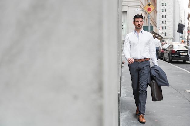 Free photo confident man walking to work