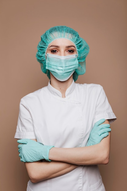 Free photo confident microbiologist wearing gloves mask and surgical cap