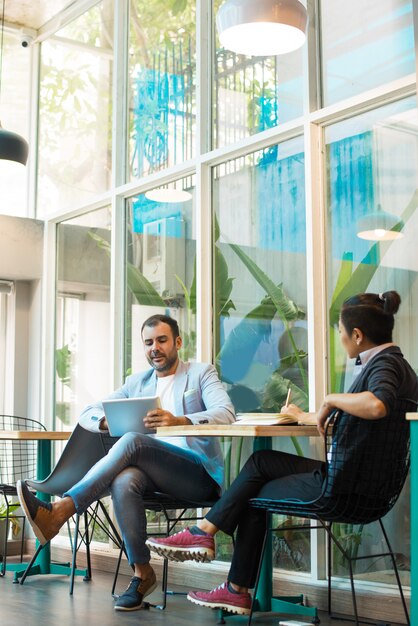 Confident multiethnic colleagues having informal meeting in cafe