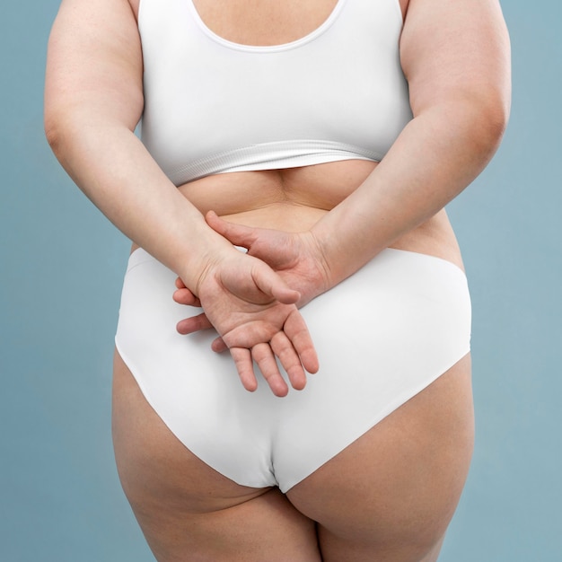 Confident oversized woman posing in lingerie