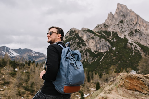 Free Photo confident pleased man with smile looking in the sky enjoying fresh mountain air during trip