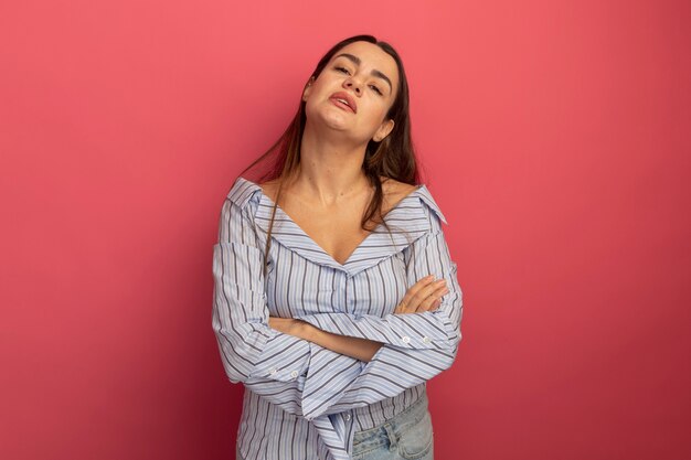 Confident pretty caucasian woman stands with crossed arms isolated