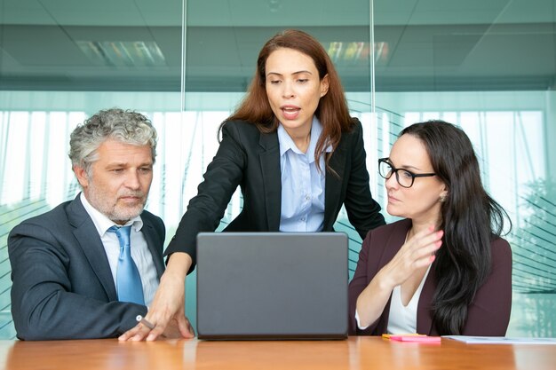 Confident project manager showing presentation to colleagues.