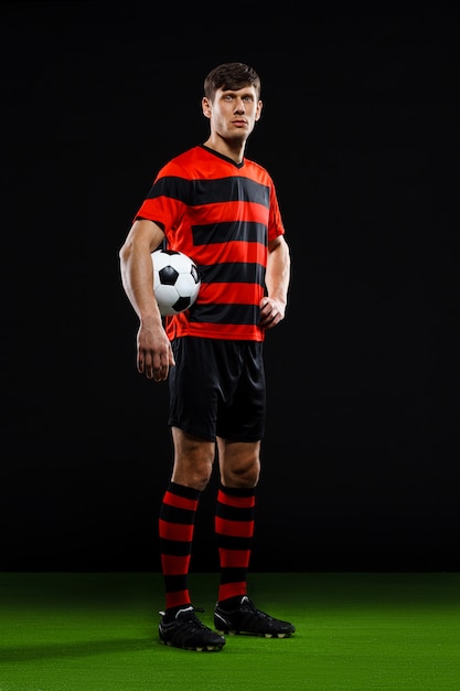 Free photo confident soccer player with ball, play football