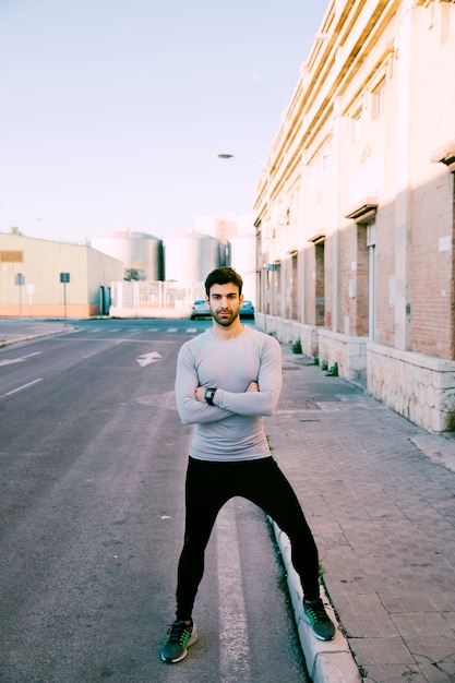 Confident sportsman on street