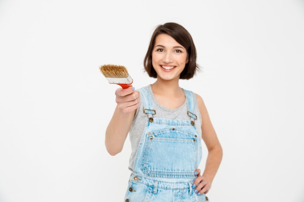 Confident woman builder with painting brush