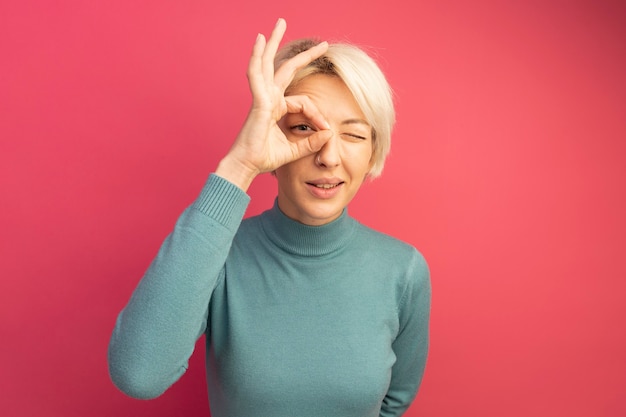 Confident young blonde girl doing look gesture 