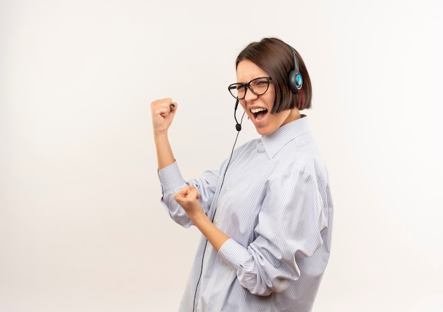 Free Photo confident young call center girl wearing glasses and headset standing in profile view gesturing strong isolated on white  with copy space