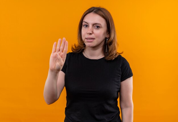 Confident young casual woman showing four on isolated orange space with copy space